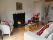 open fire with sofa and armchairs